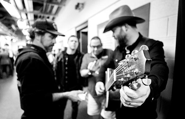 Jeff Hyde backstage tuning his guitar